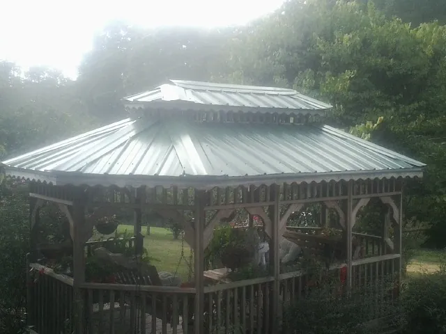 Two tier green metal roof on a garden gazebo in Raymond